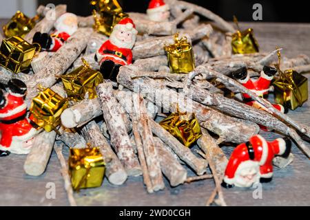 Christmas decorations made from sticks, Santas and presents on the table Stock Photo