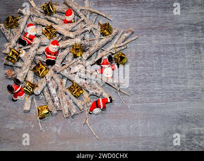 Christmas decorations made from sticks, Santas and presents on the table Stock Photo