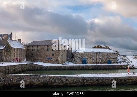 17 January 2024. Portsoy, Aberdeenshire, Scotland. This is Portsoy harbour following snow storms and a stormy sky. This was where the end of Peaky Bli Stock Photo