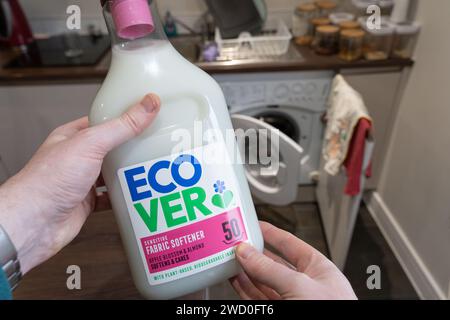 Hands holding a bottle of environmentally friendly fabric softener with plant based biodegradable ingredients by Ecover, a Belgian company. UK Stock Photo