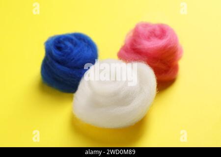 Colorful felting wool on yellow background, closeup Stock Photo