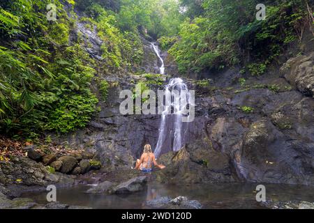 A young woman at the Gembleng Waterfall in Bali Island, Indonesia Stock ...