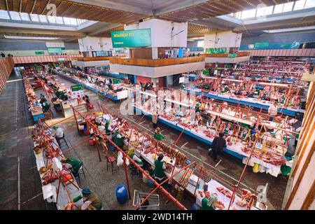 An overview look at the rows of vendors, including many meat butchers. At the main local, Soviet era food market, the Green Bazaar. In Almaty, Kazakhs Stock Photo