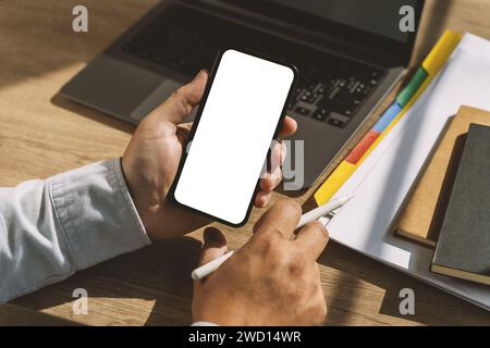 mock up phone in man hand showing white screen Hand with blank cellphone display Stock Photo