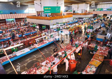 An overview look at the rows of vendors, including many meat butchers. At the main local, Soviet era food market, the Green Bazaar. In Almaty, Kazakhs Stock Photo