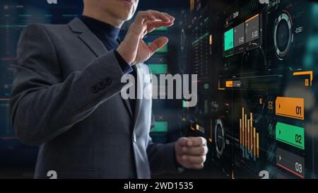 Businessman in the office interacting to augmented reality or virtual touch screen for business and stock exchange data analysis Stock Photo