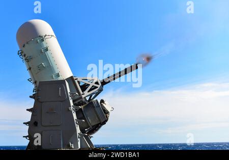 A close-in weapons system is fired remotely on the fantail of USS Iwo Jima. Stock Photo
