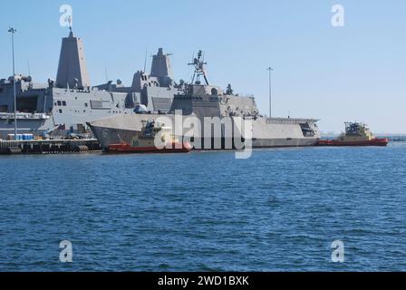 Tug boats moor the Independence-variant littoral combat ship USS Jackson. Stock Photo