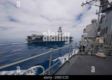 USS Shoup pulls alongside the aircraft carrier USS Nimitz in the Pacific Ocean. Stock Photo