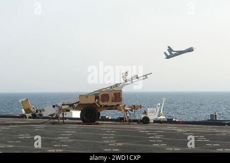 A Scan Eagle unmanned aerial vehicle is launched from the flight deck of USS Ponce. Stock Photo