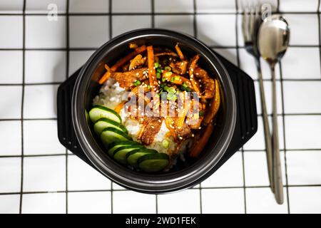 Rice And Stir Fried Pork With Korean Sauce. stir-fried pork with kimchi on topped rice - Korean food style. Stock Photo