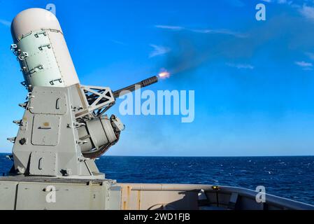 The aft close-in weapons system fires off the port side of USS Iwo Jima. Stock Photo