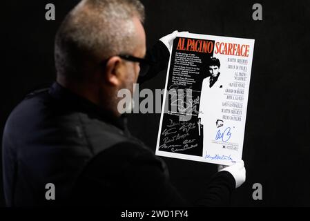 Propstore poster consultant Mark Hochman looks at an Al Pacino, Robert Loggia, Steven Bauer, Mark Margolis, Geno Silva, Mary Elizabeth Mastrantonio and others autographed mini poster for the 1983 film 'Scarface' (estimate £1,000 - £2,000) during a preview for Propstore's UK poster auction, at the Propstore in Rickmansworth, Hertfordshire. Picture date: Wednesday January 17, 2024. Stock Photo