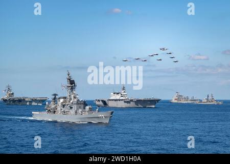 Ships and aircraft of the U.S. Navy, Japanese Navy and Royal Canadian Navy in formation in the Philippine Sea. Stock Photo