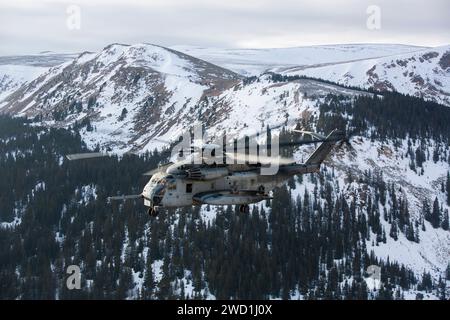 A U.S. Marine Corps CH-53E Super Stallion flies over the Rocky Mountains. Stock Photo