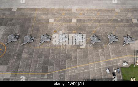 Eight U.S. Air Force F-22 Raptors sit on the flightline at Yokota Air Base, Japan. Stock Photo