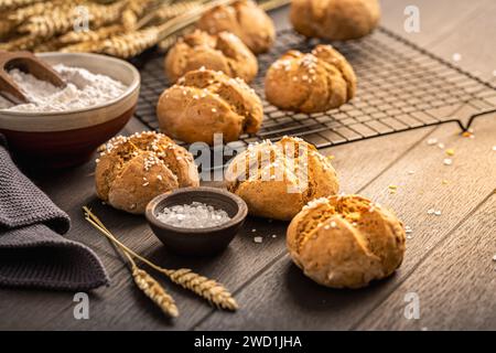 Homemade spelt bread buns with salt on wooden background Stock Photo