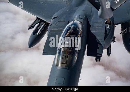 A U.S. Air Force F-15E Strike Eagle receives in-flight fuel from a KC-135 Stratotanker. Stock Photo