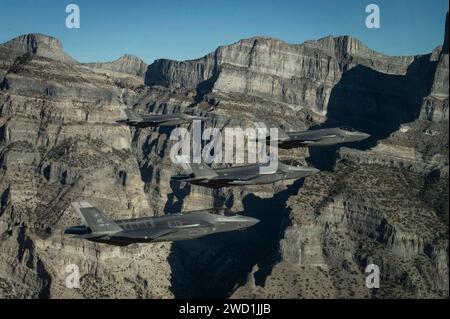 A formation of U.S. Air Force F-35 Lightning II aircraft perform aerial maneuvers. Stock Photo