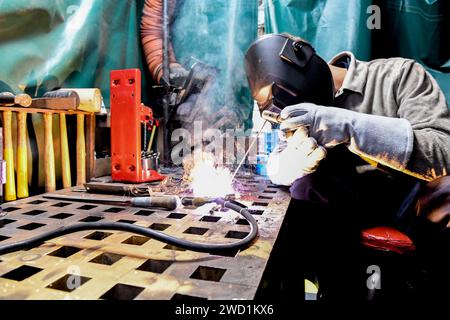 US Navy Hull Technician Fireman practices welding techniques aboard the ...