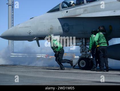 Sailors prepare an F/A-18F Super Hornet to be launched. Stock Photo