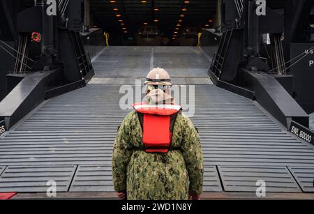 Boatswain's Mate supervises the connection of the Improved Navy Lighterage System Roll-on/Roll-off Discharge Facility. Stock Photo