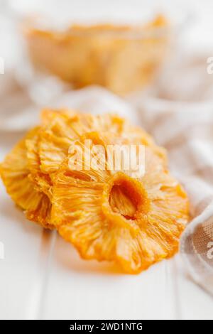 Dried pineapple rings on the white table. Stock Photo