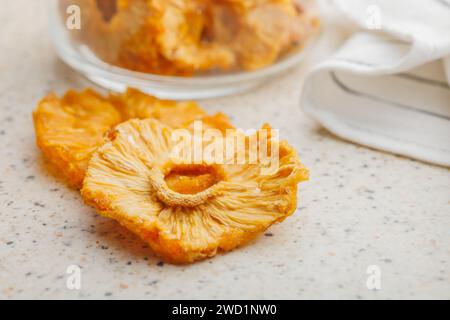 Dried pineapple rings on the kitchen table. Stock Photo