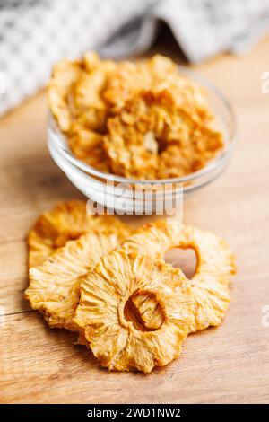 Dried pineapple rings on the wooden table. Stock Photo