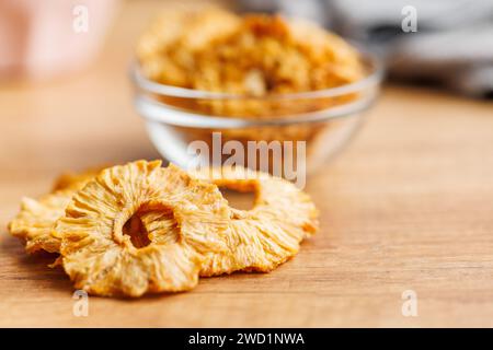 Dried pineapple rings on the wooden table. Stock Photo