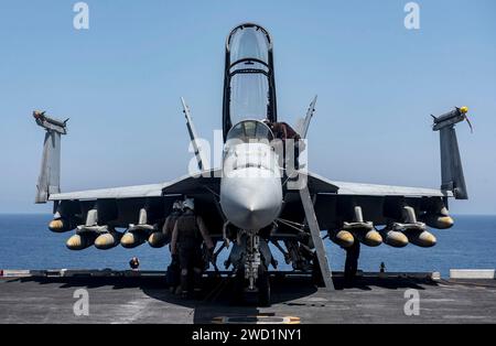 An F/A-18F Super Hornet is fully loaded with 10 GBU-32 1,000 pound bombs. Stock Photo