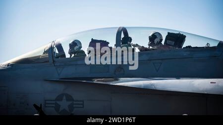 Pilots taxi an F/A-18F Super Hornet aboard the aircraft carrier USS Dwight D. Eisenhower. Stock Photo