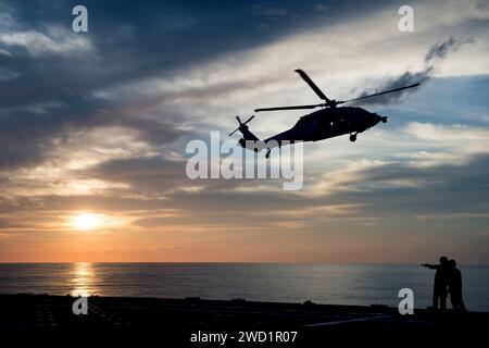 An MH-60S Sea Hawk helicopter conducts deck landing qualifications aboard USS Coronado. Stock Photo