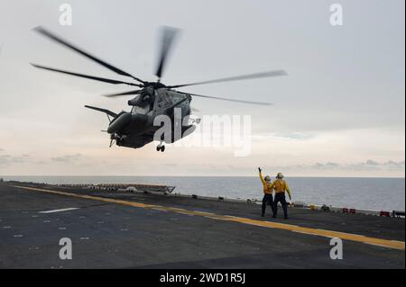 A CH-53E Super Stallion helicopter takes off from the flight deck of USS America. Stock Photo