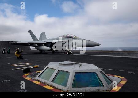 An F/A-18F Super Hornet prepares to launch from the aircraft carrier USS Theodore Roosevelt. Stock Photo