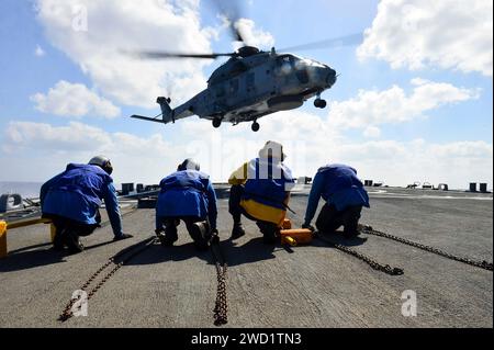 A helicopter lands on the flight deck of USS Porter. Stock Photo