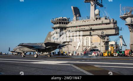 An F-35C Lightning II prepares to make an arrested cable landing on the flight deck of USS Carl Vinson. Stock Photo