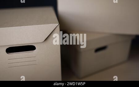 Empty solid cardboard boxes with covers, beige containers to storage things Stock Photo