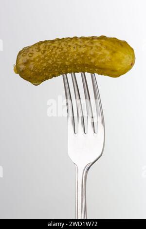 Close up of a Pickled gherkin on fork Stock Photo