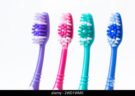 Four colourful plastic toothbrushes Stock Photo