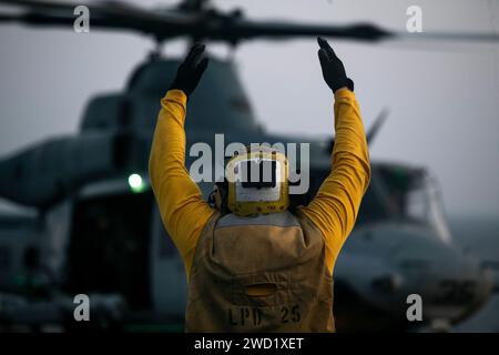 Aviation Boatswain's Mate  directs a Marine Corps UH-1Y Venom. Stock Photo