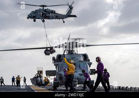 Sailors conduct flight operations aboard USS America during a replenishment-at-sea. Stock Photo