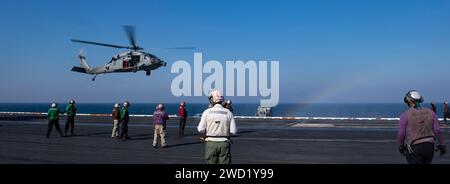 An MH-60S Sea Hawk helicopter lands on the flight deck of USS Nimitz. Stock Photo