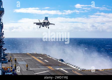 A U.S. Marine Corps F-35B Lightning II prepares to land on the flight deck of USS Makin Island. Stock Photo