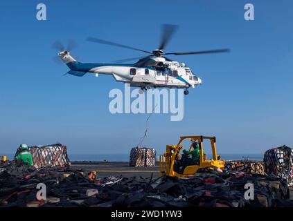 A Super Puma (EC-225) helicopter unloads cargo on the flight deck of USS Nimitz. Stock Photo