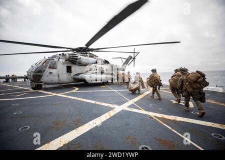 U.S. Marines load onto a CH-53 Sea Stallion during an air assault off the shore of San Clemente, California. Stock Photo
