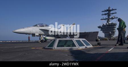 An F/A-18F Super Hornet prepares to launch off the flight deck of USS Nimitz. Stock Photo