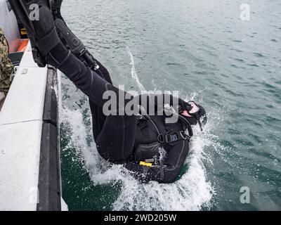 U.S. Navy diver enters the water for a mooring buoy inspection at Commander, Fleet Activities Sasebo, Japan. Stock Photo