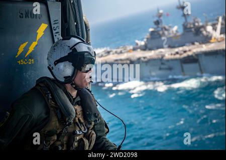 U.S. Navy Aircrewman rides in an MH-60S Seahawk helicopter. Stock Photo