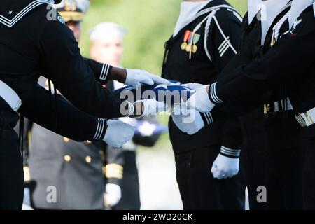 The U.S. Navy Ceremonial Guard participates in a graveside service of a fallen service member. Stock Photo